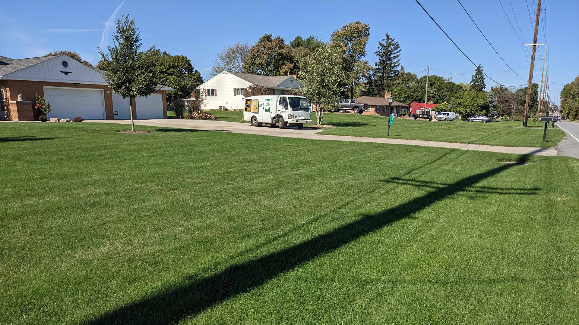 Weed-free lawn with thick grass and service truck nearby in Galion, OH.